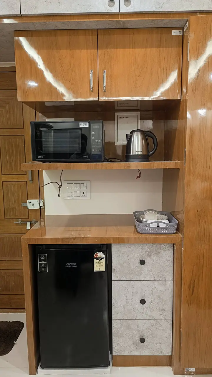 Kitchenette with microwave, kettle, mini-fridge and drawers