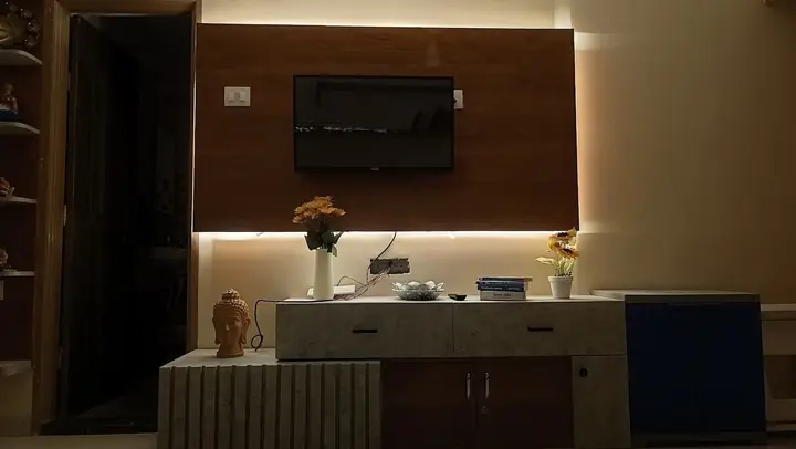 Backlit TV wall with console and decor in the evening